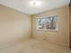 Comfortable bedroom with neutral carpet, classic wallpaper, and a bright window at 2433 S Oneida St, Denver, CO 80224