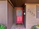 Inviting front entrance with a red door, brick accents, and visible house number at 2433 S Oneida St, Denver, CO 80224