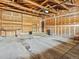 Two car garage features unfinished walls, overhead storage, and concrete flooring at 2433 S Oneida St, Denver, CO 80224