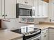 Kitchen with a stainless steel microwave and cooktop island at 2433 S Oneida St, Denver, CO 80224