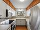 Updated kitchen featuring stainless steel appliances, white cabinets, and tile countertops at 2433 S Oneida St, Denver, CO 80224