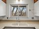 Close up of kitchen sink with large window that allows for natural light at 2433 S Oneida St, Denver, CO 80224