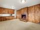 Inviting living room featuring a wood-burning fireplace and wood-paneled walls at 2433 S Oneida St, Denver, CO 80224