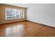 Sun-drenched living room with hardwood floors and large windows offering ample natural light at 2433 S Oneida St, Denver, CO 80224