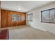 Spacious living room featuring natural light and charming wood-paneled accent wall at 2433 S Oneida St, Denver, CO 80224