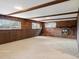 Spacious living room featuring wood beams, a fireplace, and exposed brick at 2433 S Oneida St, Denver, CO 80224