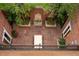 Aerial view of the patio featuring trees, brick accents, a stone fountain, and tile floors at 445 Madison N St, Denver, CO 80206