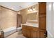 Bathroom with a granite countertop vanity, tiled bathtub and shower, and ample cabinet space at 445 Madison N St, Denver, CO 80206