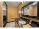 Bathroom with a marble shower, vanity with a black countertop, and framed mirror at 445 Madison N St, Denver, CO 80206