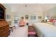 Bright bedroom featuring vaulted ceilings, neutral tones, and a charming seating area with natural light at 445 Madison N St, Denver, CO 80206