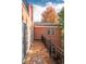 Exterior balcony with tile flooring, metal railing, and view of the building and autumn trees at 445 Madison N St, Denver, CO 80206