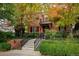 Attractive brick home featuring a balcony and a charming gated front yard at 445 Madison N St, Denver, CO 80206