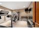Well-equipped home gym with weight rack, multi-station machine, and treadmill at 445 Madison N St, Denver, CO 80206