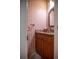 Elegant powder room with patterned wallpaper, wooden vanity, granite counter, and bronze fixtures at 445 Madison N St, Denver, CO 80206