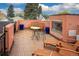 Rooftop deck with teak flooring and comfortable seating around fireplace offering an ideal outdoor living space at 445 Madison N St, Denver, CO 80206