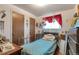 Modest bedroom with blue floral bedding, decor, and ample storage solutions including a built-in desk at 6933 W 52Nd Pl, Arvada, CO 80002
