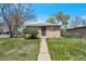 Charming brick home with a tidy front yard and decorative security door at 6933 W 52Nd Pl, Arvada, CO 80002