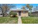 Charming brick home with a tidy front yard and decorative security door at 6933 W 52Nd Pl, Arvada, CO 80002