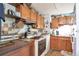 Functional kitchen with wooden cabinetry, vintage appliances, and pegboard at 6933 W 52Nd Pl, Arvada, CO 80002