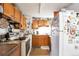 Functional kitchen features wooden cabinetry and vintage appliances at 6933 W 52Nd Pl, Arvada, CO 80002