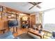 Living room with wood paneling, ceiling fan, vintage furniture and ladder at 6933 W 52Nd Pl, Arvada, CO 80002