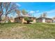 Brick home with a large grassy yard and detached garage at 6933 W 52Nd Pl, Arvada, CO 80002