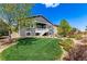 Well-maintained backyard featuring lush green lawn, mature trees, and lovely landscaping at 15122 Uinta St, Thornton, CO 80602