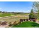 Expansive backyard view showcasing the well-manicured lawn and serene golf course surroundings at 15122 Uinta St, Thornton, CO 80602