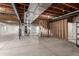 Unfinished basement with wooden beam ceiling and concrete floor at 15122 Uinta St, Thornton, CO 80602
