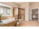 Bright primary bathroom boasts garden tub, tiled shower, and walk-in closet at 15122 Uinta St, Thornton, CO 80602