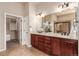 Spacious primary bath features double vanity, a large mirror, and a walk-in closet at 15122 Uinta St, Thornton, CO 80602