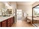 Large bathroom features double vanity, garden tub, shower, and access to primary bedroom at 15122 Uinta St, Thornton, CO 80602