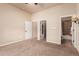 Carpeted bedroom with paneled doors to closet and bathroom at 15122 Uinta St, Thornton, CO 80602