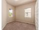 Cozy bedroom with neutral walls and carpet has sunny windows and built-in shelving at 15122 Uinta St, Thornton, CO 80602