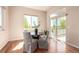 Bright breakfast nook with wood floors, large windows, and sliding door access to the deck at 15122 Uinta St, Thornton, CO 80602