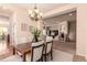 Elegant dining area with a chandelier and view into the living room, perfect for entertaining guests at 15122 Uinta St, Thornton, CO 80602