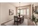 Cozy dining room with a bay window, chandelier, and neutral tones creating an inviting atmosphere at 15122 Uinta St, Thornton, CO 80602