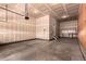 Spacious unfinished garage with concrete floor, workbench, and plenty of room for storage at 15122 Uinta St, Thornton, CO 80602