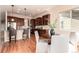 Open kitchen with granite countertops, dark wood cabinets, and an adjacent breakfast area perfect for casual dining at 15122 Uinta St, Thornton, CO 80602