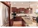 Modern kitchen featuring stainless steel appliances, granite countertops, and abundant cabinet space at 15122 Uinta St, Thornton, CO 80602