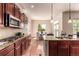 Stylish kitchen with granite counters and view to eat-in kitchen area and backyard at 15122 Uinta St, Thornton, CO 80602