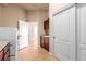 Functional laundry room with sink, storage cabinets, tile floors, and machines at 15122 Uinta St, Thornton, CO 80602
