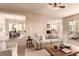 Inviting open-concept living room with a view into the dining area and kitchen, creating a seamless flow at 15122 Uinta St, Thornton, CO 80602