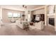 Bright living room with neutral colors, large windows, a fireplace, and comfortable seating arrangements at 15122 Uinta St, Thornton, CO 80602