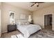 Bright primary bedroom with ceiling fan, decorative rug, and two sunny windows at 15122 Uinta St, Thornton, CO 80602