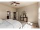 Primary bedroom with hallway, bath access, and decorative table with arched mirror at 15122 Uinta St, Thornton, CO 80602