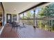 Outdoor deck with seating and views of trees at 6991 S Lee Way, Littleton, CO 80127