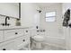 Clean, bright bathroom with white vanity, black hardware, and shower/tub combination at 6991 S Lee Way, Littleton, CO 80127