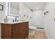 Modern bathroom with wood vanity, updated fixtures, and a walk-in shower at 6991 S Lee Way, Littleton, CO 80127