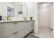 Bathroom with dual sink vanity, modern fixtures, decorative mirror and storage at 6991 S Lee Way, Littleton, CO 80127